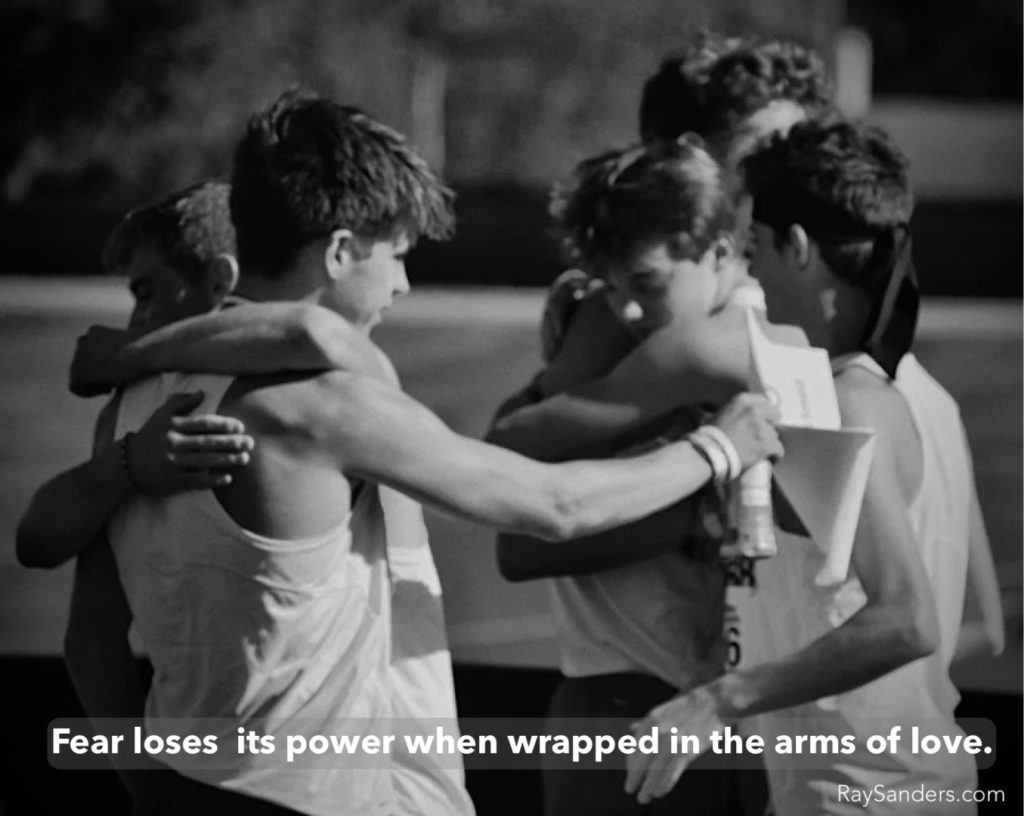 Group hug with motivational quote.
