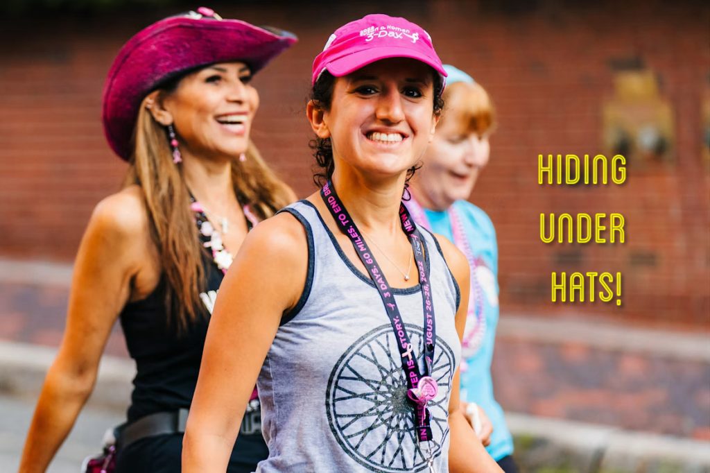 Women in hats smiling during an event.