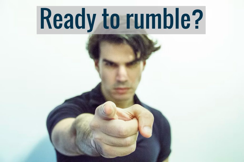 Person pointing with intense expression, ready to challenge.