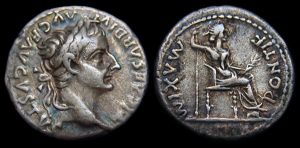 Ancient Roman coins with Emperor and seated figure.