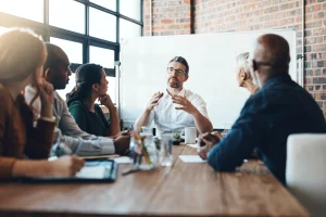 Team meeting with discussion at conference table.